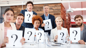 group of business owners with questions holding signs